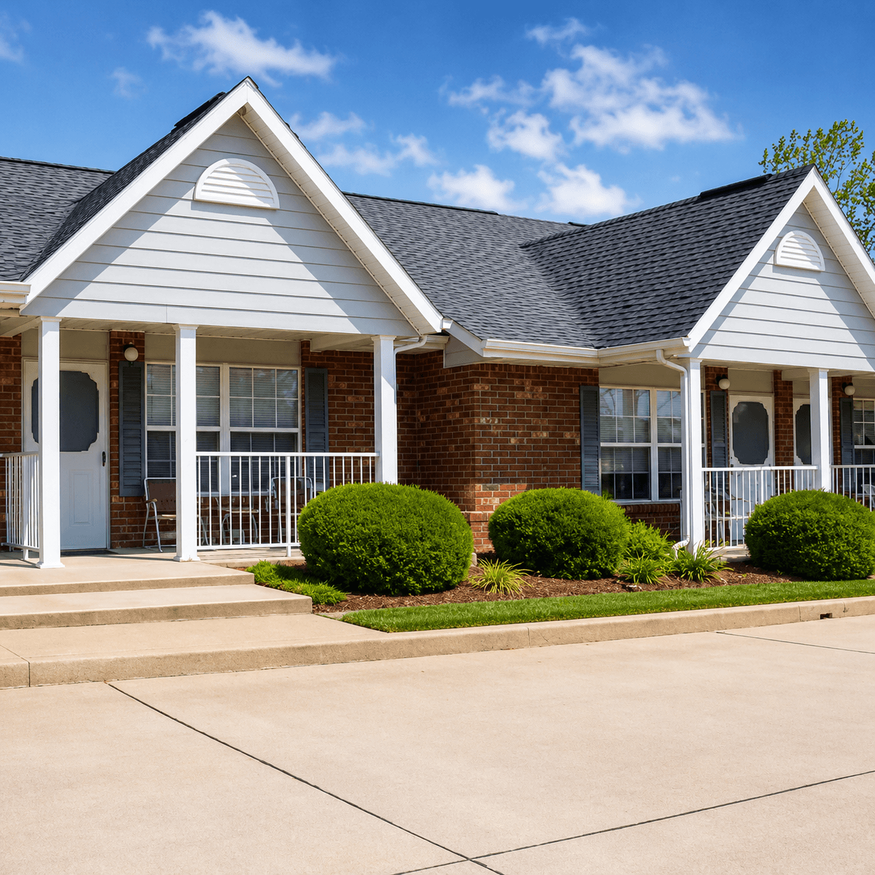 A house with a white front porch and a brick exterior.